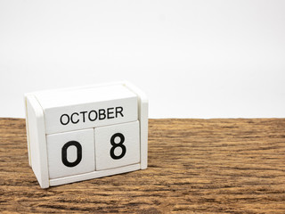 October 8 white cube wooden calendar on vintage wood and white background with autumn day,...