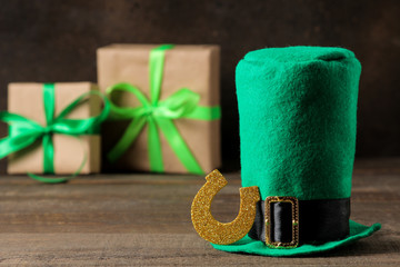 St.Patrick 's Day. celebration. Green hat of a leprechaun and a horseshoe on a brown background.
