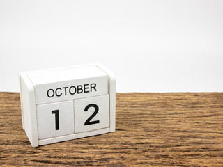 October 12 white cube wooden calendar on vintage wood and white background with autumn day,...