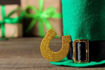 St.Patrick 's Day. celebration. Green hat of a leprechaun and a horseshoe on a brown background....