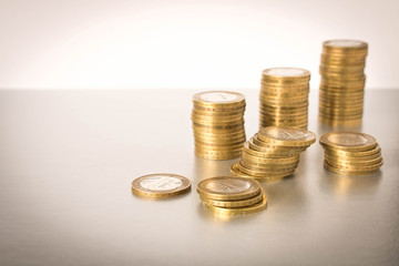 Stacks of coins on a light background. Business concept and growth of capital.
