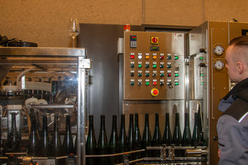 a vintner checks the functions of a filling station