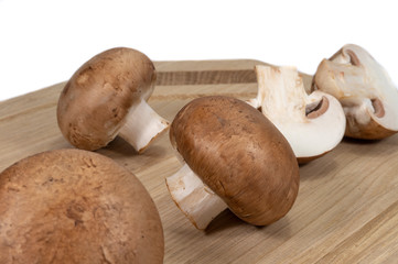 Fresh whole and halved brown Baby Bella mushrooms