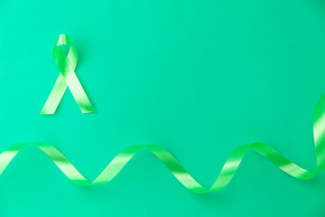 Green ribbon for Lymphoma Cancer background and mental health awareness background