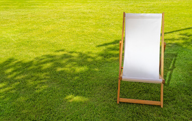 Single White Empty Deck Chair on Lawn