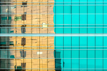 Simple, abstract, pastel color modern glassy office building exterior facade 
