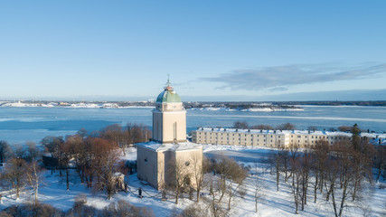 Fototapeta na wymiar Beautiful old lighthouse and church in Suomenlinna at winter season, Helsinki