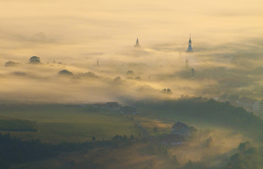 Foggy landscape in mountains, autumn sunrise, Poland