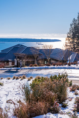 Houses in suburb at Winter with ocean view in the north America. Luxury houses covered nice snow.