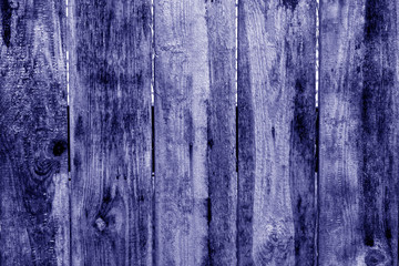Old grunge wooden fence pattern in blue tone.