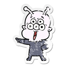 distressed sticker of a happy cartoon alien pointing