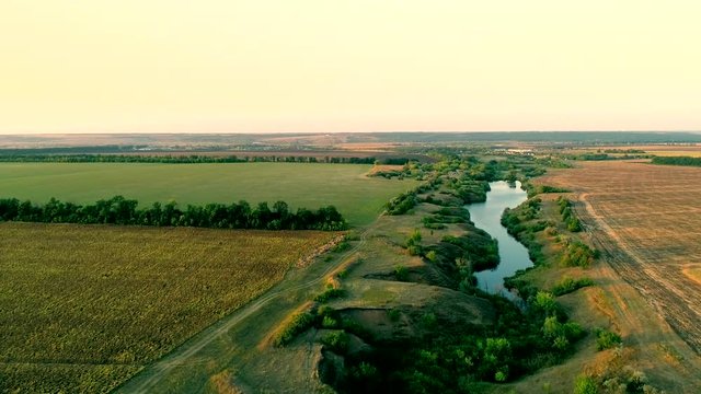 Aerial spacious view of countryside fields and river