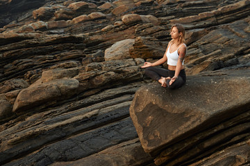 Woman Practicing Yoga in the Nature. Meditating Outdoors