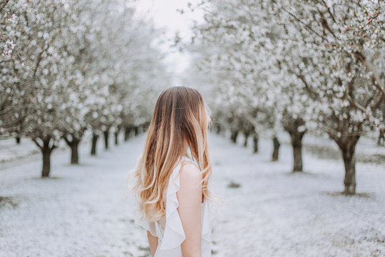Side view of woman standing on snow covered field