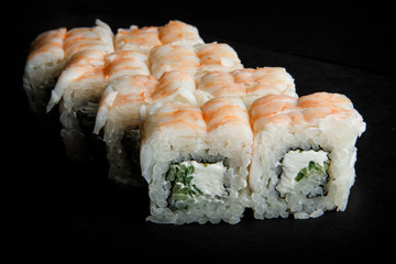 philadelphia roll sushi with cucumber, cream cheese and tiger shrimp on top