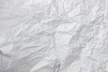 Crumpled paper texture. White battered paper background. White empty leaf of crumpled paper. Torn surface of letter blank. Copy space