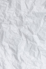 Crumpled paper texture. White battered paper background. White empty leaf of crumpled paper. Torn surface of letter blank. Copy space