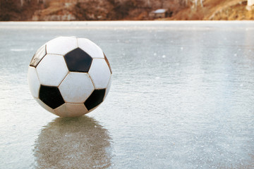 classic soccer ball on a frozen pond