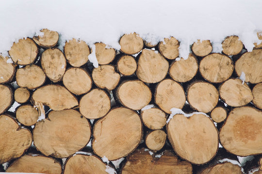 Wooden logs covered in snow