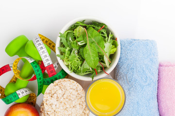Dumbells, tape measure, healthy food