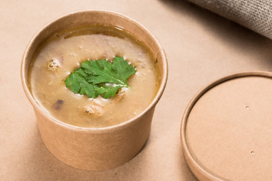 Soup in a disposable cup of craft paper