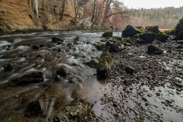 Fototapeta premium river Rak flowing over stones in Rakov Škocjan