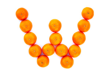 Letter solved with tangerines isolated on white background. Mandarine «W» letter
