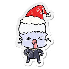 weird distressed sticker cartoon of a alien wearing santa hat