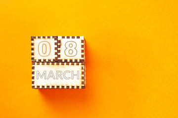 wooden cubes with the inscription March 8 on orange background. 8 march and women day concept