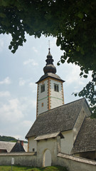 Fototapeta na wymiar View of the tower of Church of St. John the Baptist, Bohinj, Slovenia
