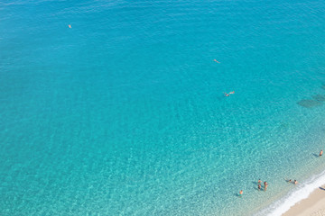 Tropea, Calabria, Italy - September 12, 2018: Top view of the beautiful endless azure sea with a small fragment of a sandy beach.