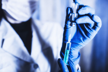 Syringe and hand closeup. The concept of vaccination, filling the drug into the syringe