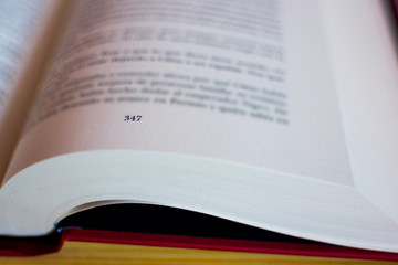 One red book open on a table background