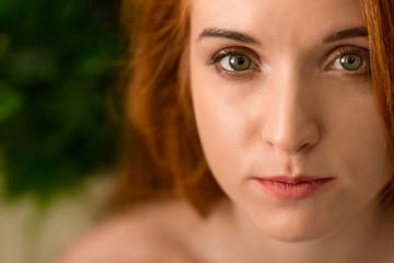 Portrait of young redhead woman with perfect skin