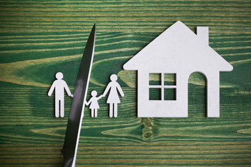 knife divides the whole family. divorce idea. wooden figure. wood background.