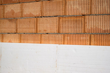 red brick wall and nsulation of white polystyrene