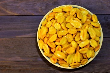 Roasted peanuts on a wooden background. Peanuts are Legumes-a popular snack, a widespread product in cooking.