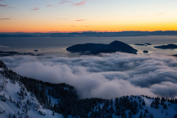 Fototapeta premium Aerial view of a beautiful Canadian Landscape during a winter sunset. Taken in Howe Sound, North of Vancouver, British Columbia, Canada.