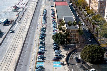 Fototapeta na wymiar Malaga, Spain, February 2019. Top view of the parking lot, cars, roads. Parking spaces for the disabled.