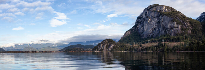 Beautiful panoramic Canadian landscape view of a popular landmark, Chief Mountain, during a cloudy sunny day. Taken in Squamish, North of Vancouver, BC, Canada.