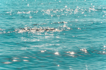 beautiful turquoise background. sea surface with lots of glare from the sun