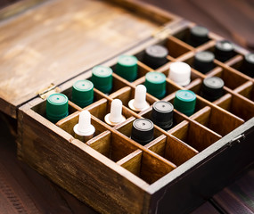 Aromatherapy essential oils in wooden box. Herbal alternative medicine with essential oils bottles...