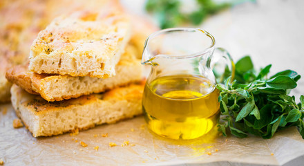 Foccacia bread with oregano herb and olive oil.Fresh italian foccacia bread closeup with mediterranean ingredients