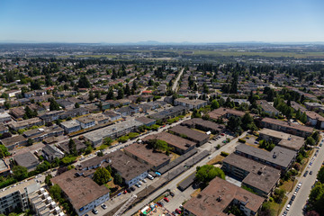 Aerial view of a residential suburban neighborhood during a sunny summer evening. Taken in Burnaby, Vancouver, BC, Canada.