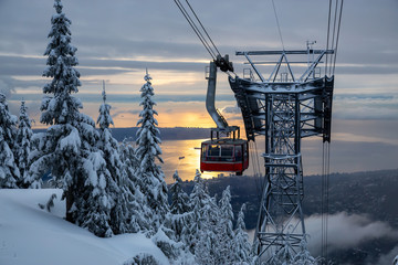 Beautiful view of a Gondola during a vibrant winter sunset. Taken in Grouse Mountain, North Vancouver, BC, Canada. © edb3_16