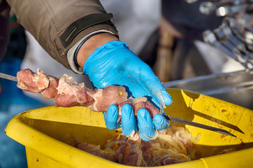 Stringing meat on a skewer.
