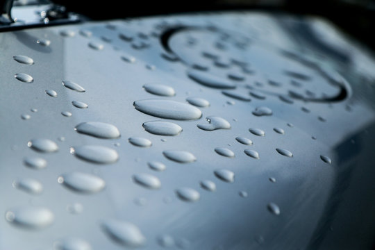 A picture of water drops on a car´s bodywork. Condensation made them during the night. 