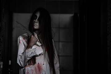 Portrait of asian woman make up ghost face with blood,Horror scene,Scary background,Halloween...
