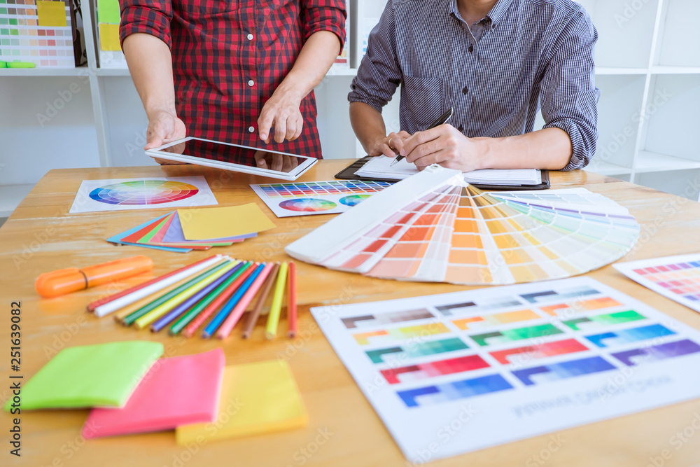 Poster teamwork of young creative designers working on project together and choose color swatch samples for