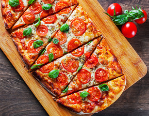 oval Pizza with Mozzarella cheese, Tomatoes, pepper, Spices and Fresh Basil. Italian pizza. Pizza...